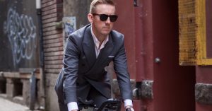 Man in suit on a road bike